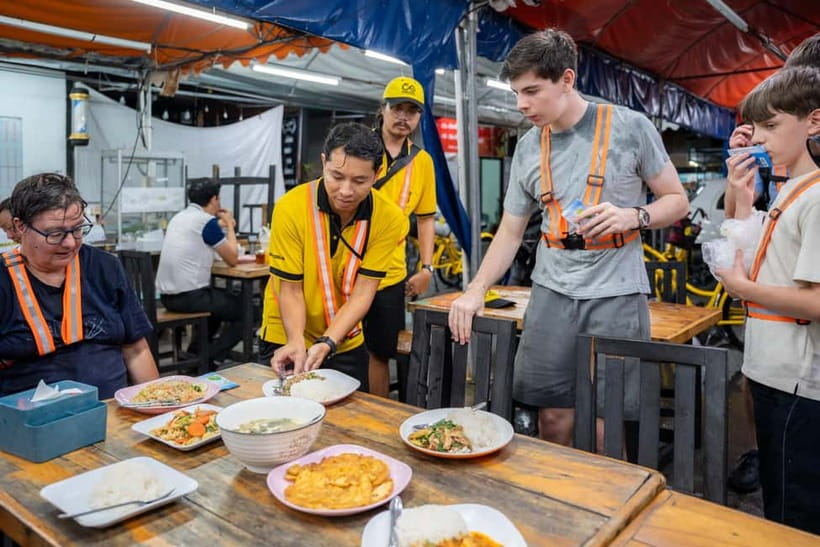 Bangkok by Night Cycling Tour with Street-food Meal - Chinatown under lanterns and shop signs