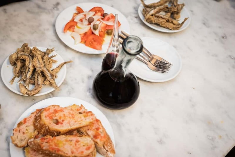 Barcelona: The Ultimate Local Tapas & Drinks Food Tour - Stop four: padron peppers, montaditos, and local variety
