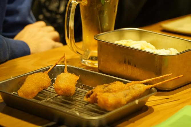 Osaka Local Foodie Walking Tour in Dotonbori and Shinsekai - Starting beneath Tsutenkaku in Shinsekai