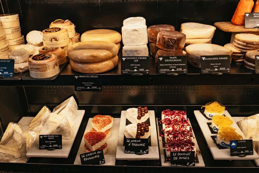Paris: Gourmet Food Tour with Over 10 Tastings and Wine - A historic market street and a sweet finish