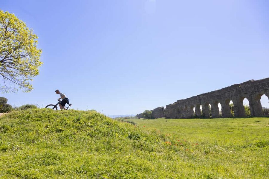 Rome: Appian Way & Aqueducts E-Bike Tour (Catacombs & Food) - Entering the catacombs beneath Rome